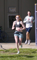 Photo of Mallory Richardson finishing the Lawrence Half Marathon.
