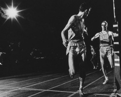 Photo of Dwight Peck receiving baton at 1966 NCAA Indoor Champs.
