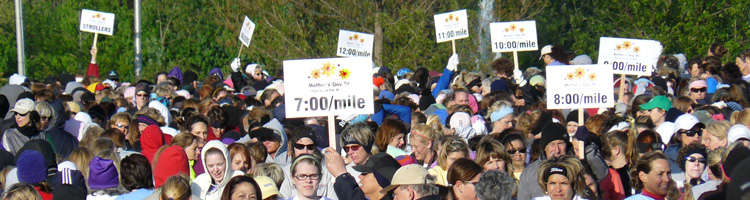 Photo of the start of the Mothers Day Run with pace signs.