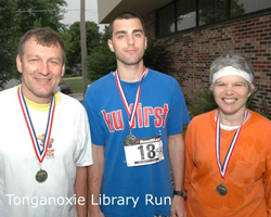 Photo of the Slocums with their medals from the Tongie Library Run.