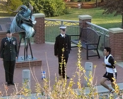 Photo of the KU Korean War Memorial with ROTC students standing vigil as the first runner comes by.