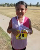 Photo of WInona Gayton with her medal from the AUg IronKids Triathlon in Oklahoma.