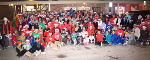 Photo of the 150 plus runners at Red Dog's Jingle Jog in downtrown Lawrence on Dec 16th.