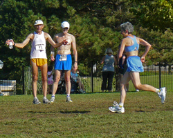 Photo of Jeff Behrens staying something to Dee Boeck at the finish of the Course of Creams XC races.