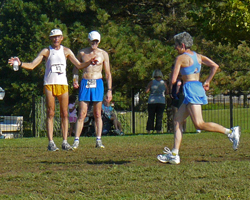 Photo of Jeff Behrens staying something to Dee Boeck  at the finish of the Course of Creams XC races.