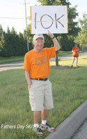 Photo of Lou Joline, the humna sign holder.