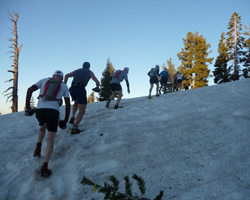 Climbing over snow at the Western States 100.