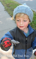 Photo of boy holding a Rug Rat Run award