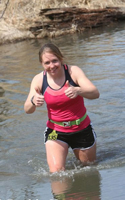 Photo of runner numbe 135 deep in the water corssing at Kanopolis State Park.