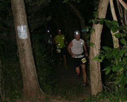 Photos of runners with headlamps on the trail.