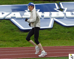 Sue Washburn rounding the last turn on the Weashburn Unviersity track at the Run for Life 10 Mile.