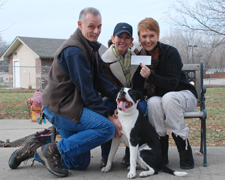 Photo of Gary Henry, Sherrie Klover presenting a check to Doiri Villalon, Lawrence Humane Society from the Sanders' Saunter Trail Run.