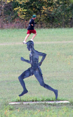 Photo of Dan Kuhlman passing the Al Frame silhouette at Rim Rock Farm at the Oct 6, 2012 Dr Bob Run.