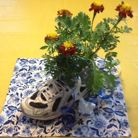 Flowers potted in running shoes wre the centerpiences at the annual runLawrence picnic at the Lawrence Visitors Center.