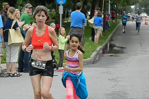 Photo of Shannon Hodges and daughter Geneva nearing the finish of the Home Run 5K.