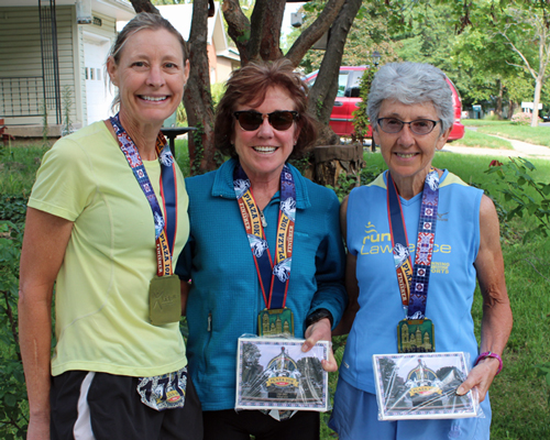 Phoo of Becky McClure, Liz Dobbins and Dee Boeck with the awards from the Plaza 10K.